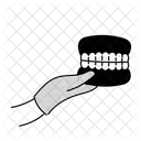 Dentist Holding Denture  Icon