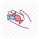 Wrapped hard candy in hand  Icon
